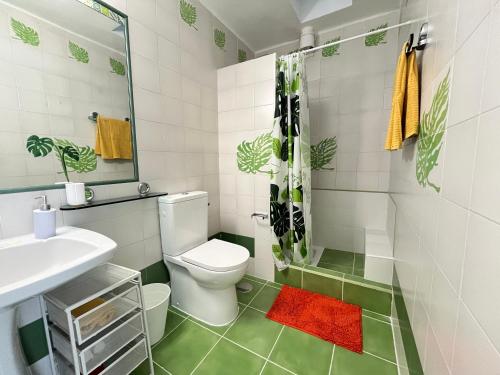a white bathroom with a toilet and a sink at Casa Oda Seaview in Puerto del Carmen