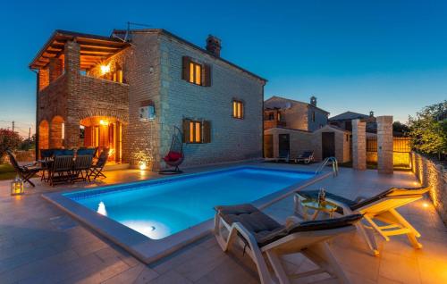 a swimming pool in front of a house at 3 Bedroom Gorgeous Home In Cabrunici in Čabrunići