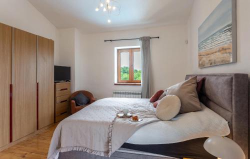 a bedroom with a bed and a couch and a television at 3 Bedroom Gorgeous Home In Cabrunici in Čabrunići