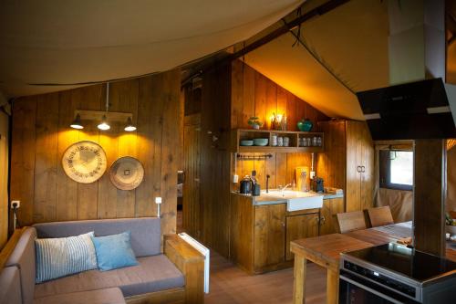 a room with a couch and a table in a kitchen at Landgut Girtenmühle in Britten