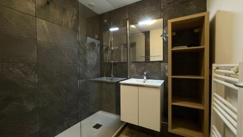 a bathroom with a sink and a mirror at Homency - Résidence Ménandière R1 in L'Alpe-d'Huez