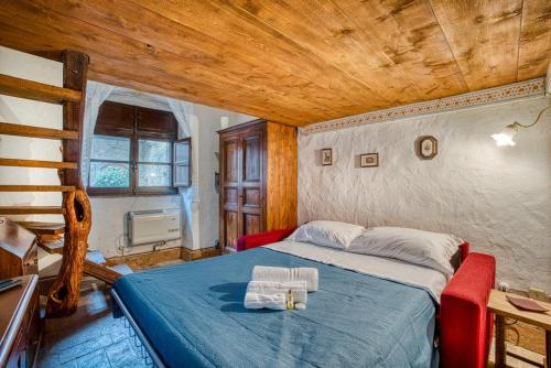 a bedroom with a bed in a room with a wooden ceiling at La Badia in Sant Arcangelo