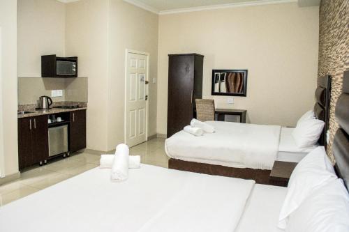 Postel nebo postele na pokoji v ubytování Bayside Hotel Pietermaritzburg