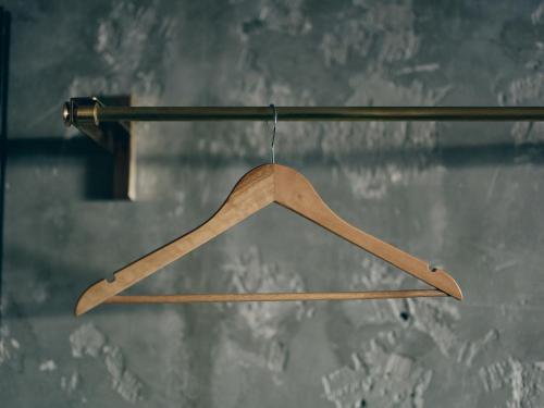 a wooden hanger hanging from a pole at illi Tas Shinjuku in Tokyo