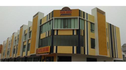 a building with a sign on the side of it at Sun Inns Hotel Pasir Penambang (KS Botanic) in Kuala Selangor