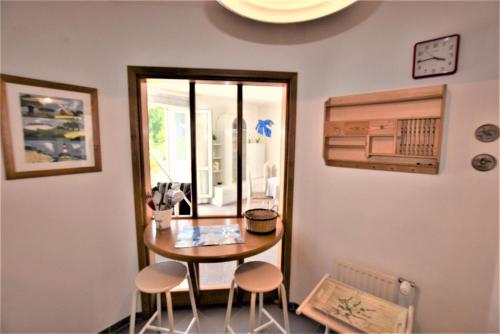 a dining room with a table and two stools at Ferienwohnung Sanddorn in Hohwacht