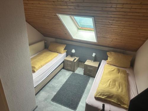 a small room with two beds and a window at Hotel-Restaurant Olympia in Selm