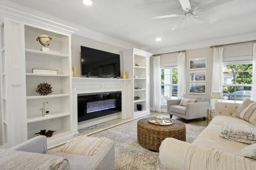a living room with a couch and a tv at Luxury home walkable to the beach in Gulfport