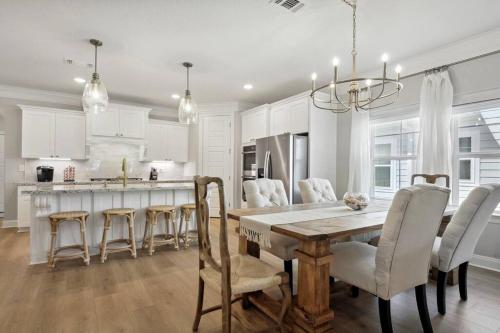 a kitchen and dining room with a table and chairs at Luxury home walkable to the beach in Gulfport