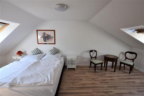 ホーヴァハトにあるFerienwohnung Alexandraのベッドとテーブルと椅子のある寝室