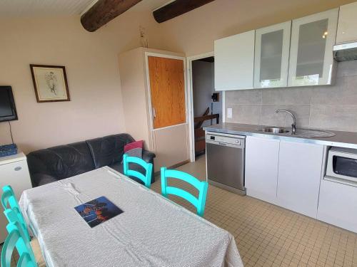 une cuisine avec une table et des chaises et une cuisine avec un évier dans l'établissement Appartement 4 pers, 2 chambres, pied des pistes, balcon sud - Saint-Michel-de-Chaillol - FR-1-393-139, à Saint-Michel-de-Chaillol