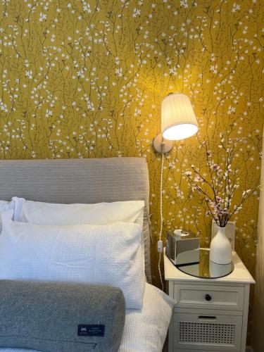 a bedroom with a bed and a table with a lamp at Balmridge House, Loch Ness, Bed & Breakfast in Drumnadrochit