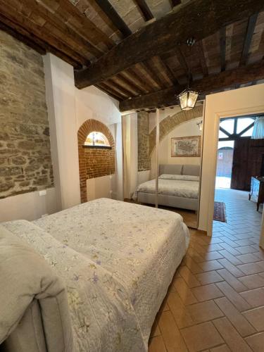 a bedroom with a bed and a mirror in it at Dimora Borgo dei lanari in Città di Castello