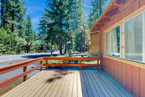 a wooden deck with a bench on the side of a house at Pineland Escape in Tahoe City