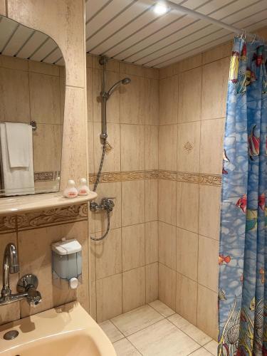 a bathroom with a shower and a toilet at Hotel Jambo in Golden Sands