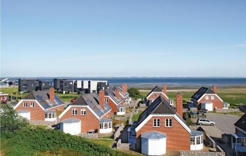 a group of houses on a hill near the ocean at Holiday Home Sdr Frankel Rømø Denm in Havneby