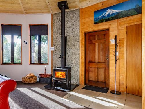 a wood stove in a room with a door at Turoa Yurt - Ohakune Holiday Home in Ohakune
