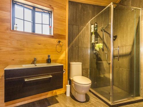 a bathroom with a shower and a toilet and a sink at Turoa Yurt - Ohakune Holiday Home in Ohakune