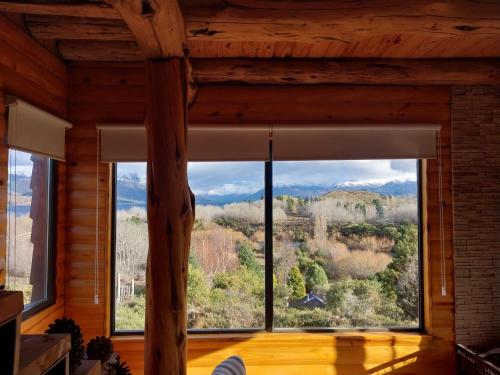 a large window in a room with a mountain view at Entre Nubes in Junín de los Andes