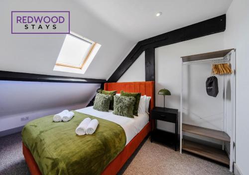a bedroom with a bed with towels on it at Comfortable and Homely 1-Bedroom 1-Bathroom Serviced Apartment, Free Parking, Free WiFi By Redwood Stays in Farnborough