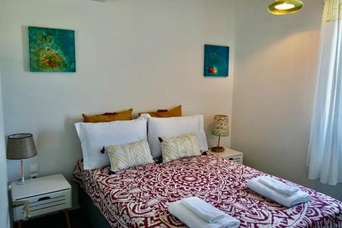 a bedroom with a bed with two towels on it at Follow Your Art in Kýthira