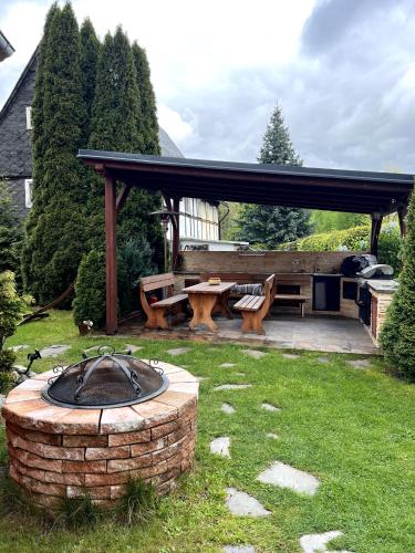 a patio with a bench and a picnic table at Haus mit Pool Großschönau in Großschönau