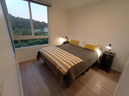 Giường trong phòng chung tại Oceana Suites Costa Quilen