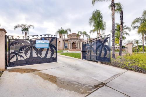 a gate in front of a house with palm trees at 10 Mi to Dtwn Riverside Triplex with Pool in Riverside
