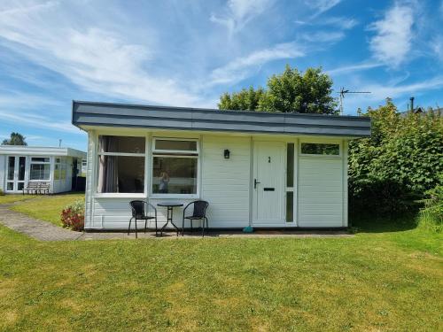 a tiny house with a table and two chairs at Hideaway in Pembrokeshire