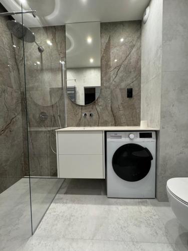 a washing machine in a bathroom with a shower at VIP Apartament Kopisto CENTRUM in Rzeszów