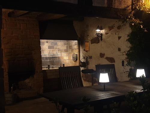 two chairs and a table with two lights on it at Wolfsmühle in Speckswinkel