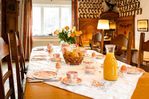 a table with food and a vase of flowers on it at Wolfsmühle in Speckswinkel