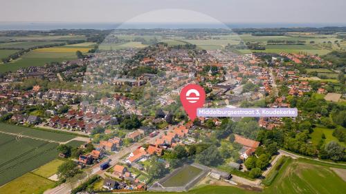 a red stop sign in the middle of a city at Welcome in - Vakantiehuis - Middelburgsestraat 61a - Koudekerke 'Villa Querina' in Koudekerke