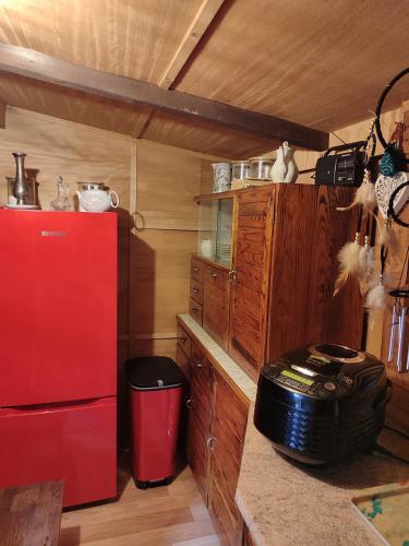 a kitchen with a red refrigerator and wooden cabinets at Lesní chata v Malé Hraštici in Malá Hraštice