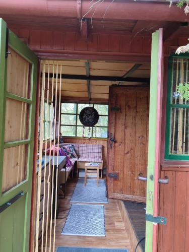 an open door of a house with a porch at Lesní chata v Malé Hraštici in Malá Hraštice