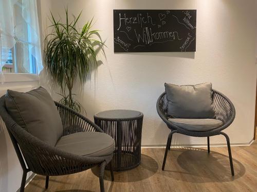 two chairs and a table in a room at Hotel Landgasthaus Neues Bild, Eggerstanden in Appenzell