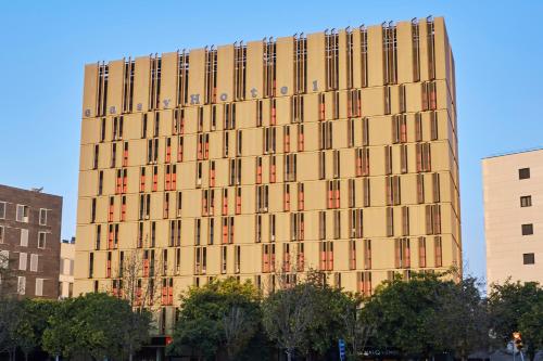 a tall building with many windows on the side of it at easyHotel Barcelona Fira in Hospitalet de Llobregat