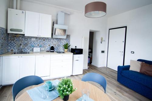 a kitchen and a living room with a table and chairs at Your Refuge in Lecco - Lake Como in Lecco