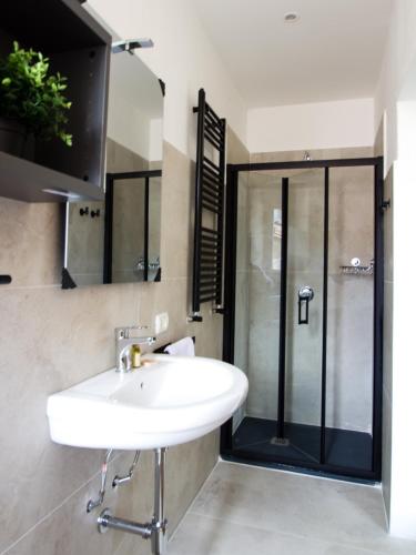 a bathroom with a sink and a shower at Your Refuge in Lecco - Lake Como in Lecco