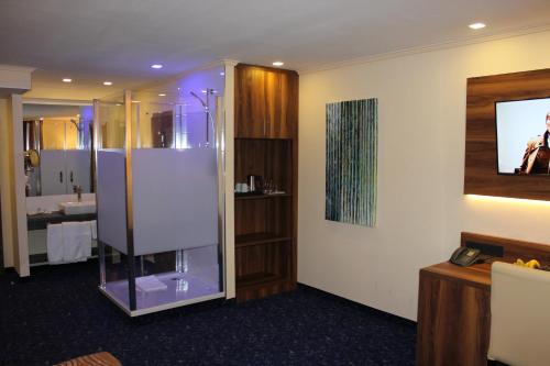 a bathroom with a glass shower in a room at Grand Hotel Empire in Frankfurt/Main