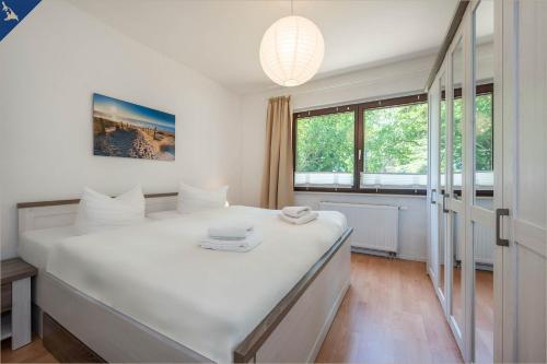 a large white bed in a room with a window at Ferienhaus Mellenthin Ferienhaus Mellenthin in Mellenthin