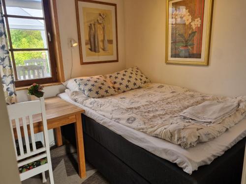 a bed in a room with a table and a window at Haby House in Skene