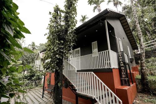 a house with a staircase leading up to it at IRON BRIDGE COVE in Meppādi