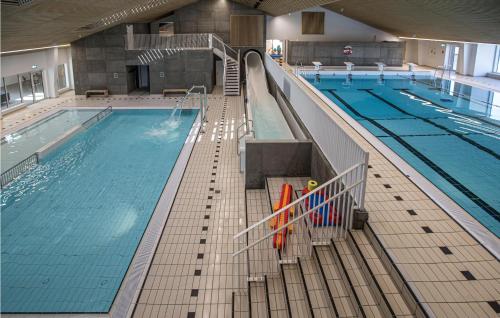 a large indoor swimming pool with a swimming pool at Lukaf in Thyborøn