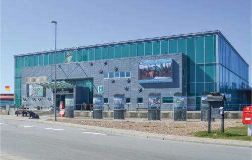 a large glass building with a billboard on the side of it at Lukaf in Thyborøn