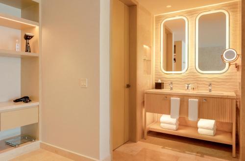 a bathroom with a sink and a mirror at The Eden by Desire Riviera Maya All Inclusive - Couples Only in Puerto Morelos