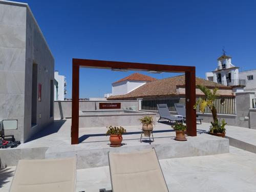 a patio with chairs and plants on a building at Hotel YIT Casa Grande in Jerez de la Frontera