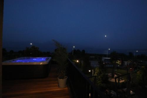 a hot tub on a balcony at night at Toka Hotel Restaurant in Pogradec