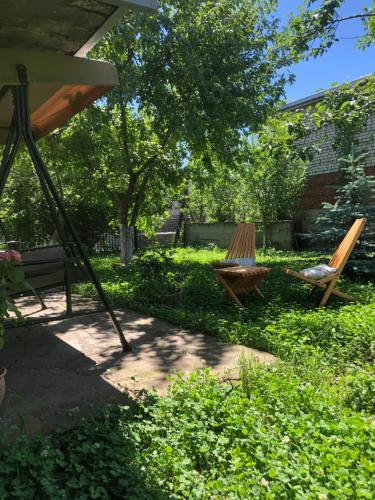 two chairs and a swing in a yard at TREFOIL in Lori Berd