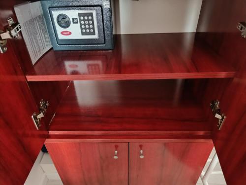 a microwave sitting on top of a wooden cabinet at Zemun Central in Zemun